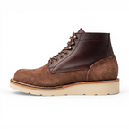 A brown suede and leather lace-up ankle boot with a thick beige sole, shown in a side profile on a white background.