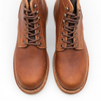 A pair of men's brown leather lace-up boots shown from a top-down view on a clean white background.