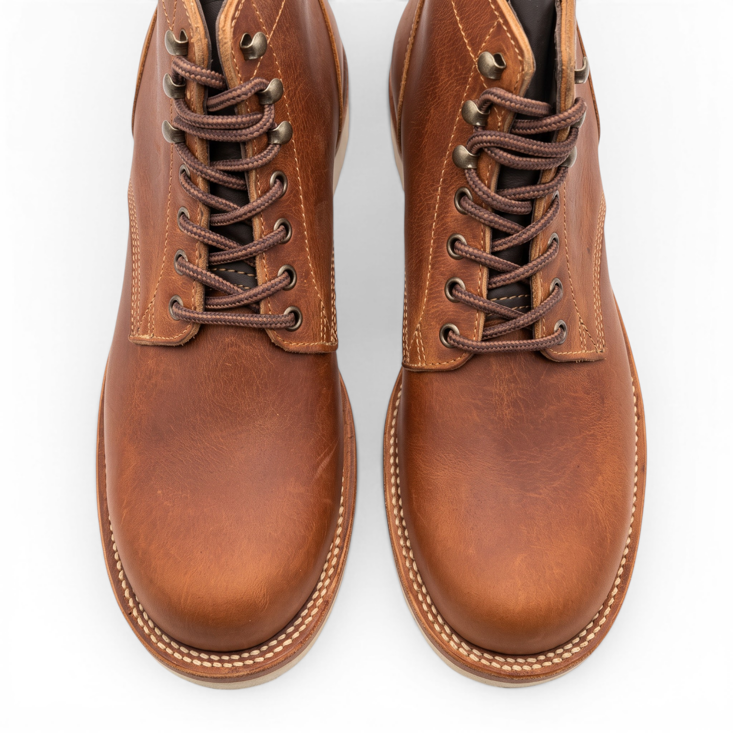 A pair of men's brown leather lace-up boots shown from a top-down view on a clean white background.